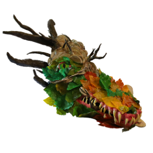 A dragon head covered in branches and leaves.